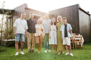 A joyful family posing together in a sunny outdoor setting, enjoying quality time.